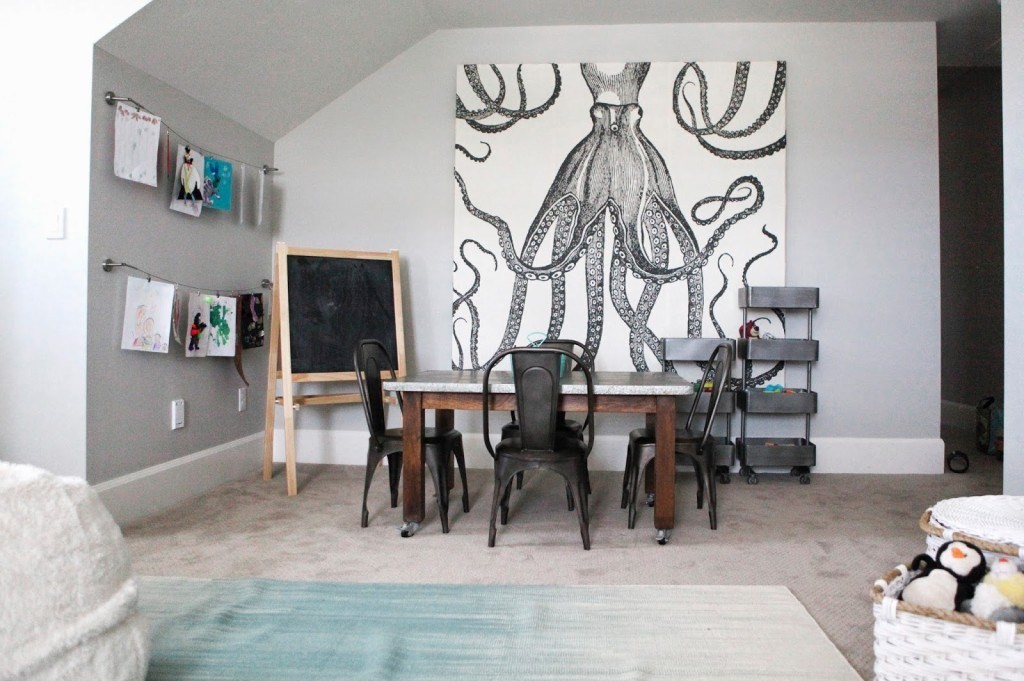 A DIY canvas portrait created with an octopus shower curtain and wood hung up in a living room. 